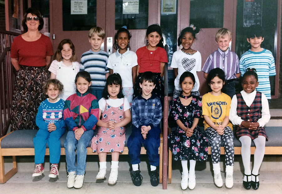 Color photograph of one of Bucknell's first grade classes taken during the 1995 to 1996 school year. 14 children are their teacher are pictured. 