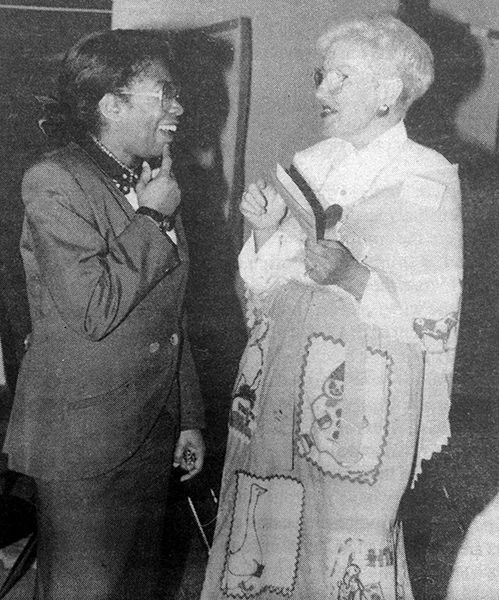 Black and white photograph from a newspaper article about Bucknell's 40th anniversary celebration. Sara Fowke and Miriam Rosenthall are engaged in conversation. 