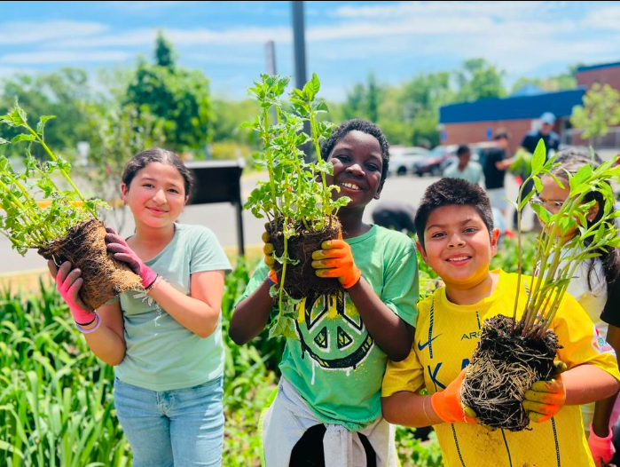 students holding plants