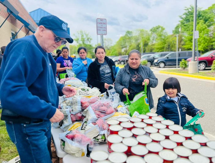 families shopping at free family food market